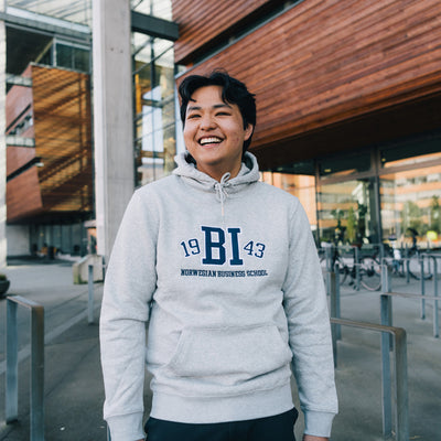 Man wearing grey hoodie with BI logo